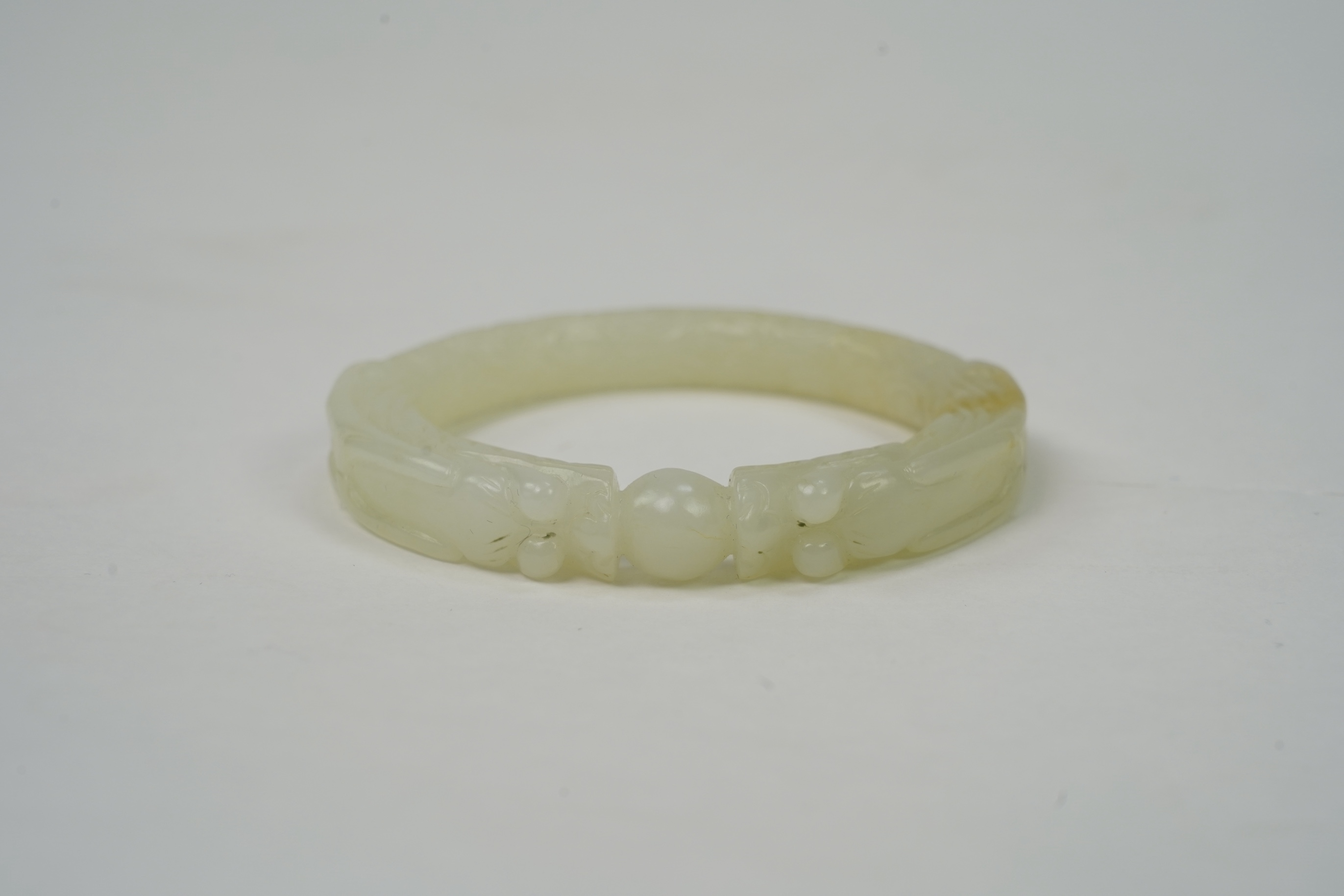 A Chinese pale celadon jade ’dragon’ bangle